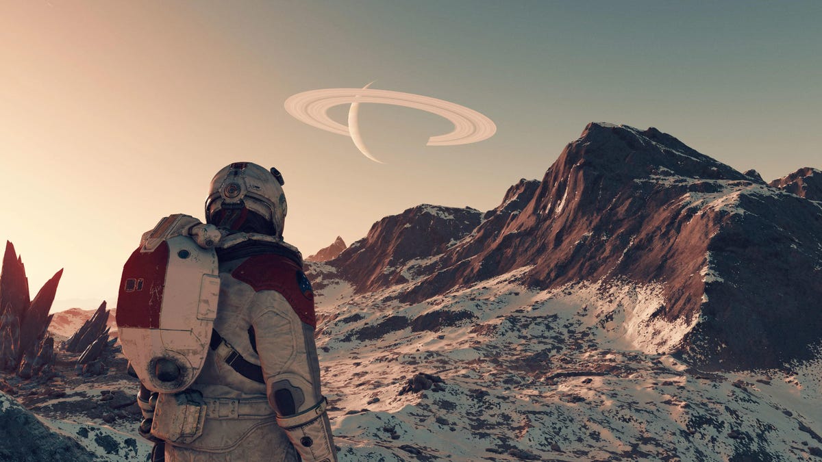 a player character looking at a mountain range on another planet